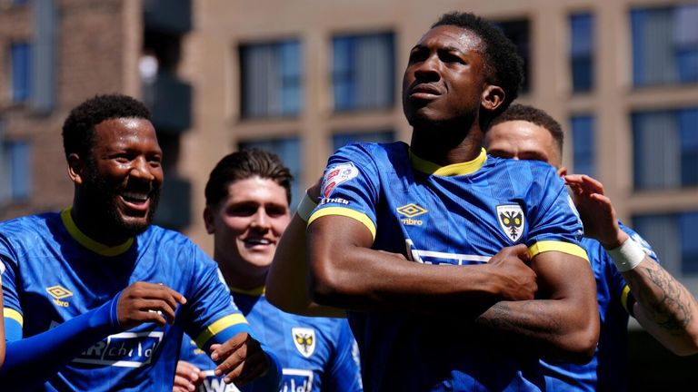Josh Neufville celebrates with his team-mates after scoring with an audacious lob against Notts County